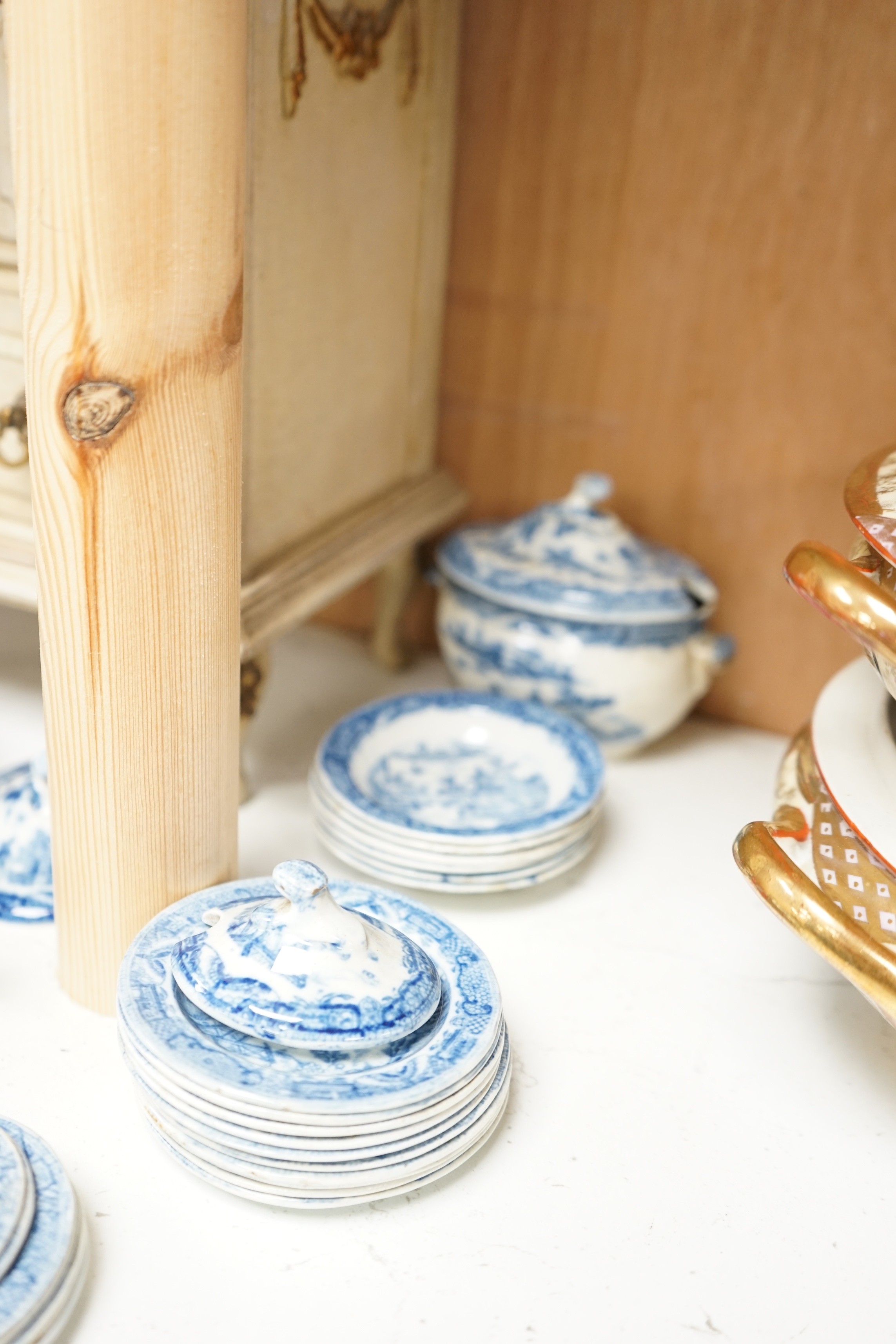 A Victorian toy-size blue and white dinner service and a painted wooden miniature chest, chest 27cms high